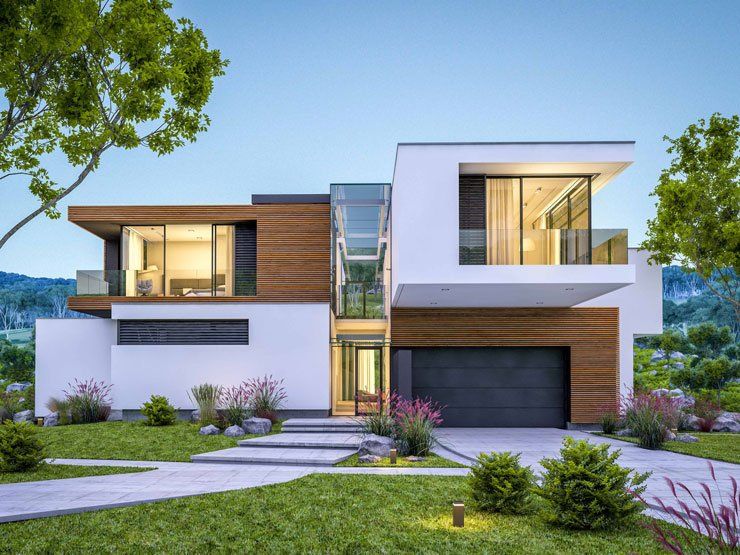 Une maison moderne avec un grand garage et beaucoup de fenêtres est située au sommet d'une colline verdoyante.