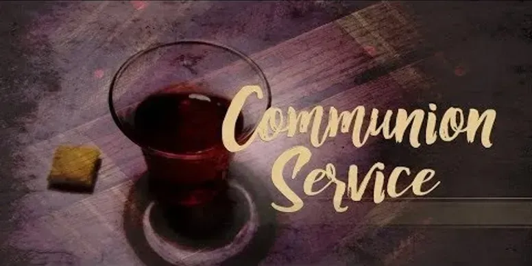 A glass of red liquid with a piece of bread, text 