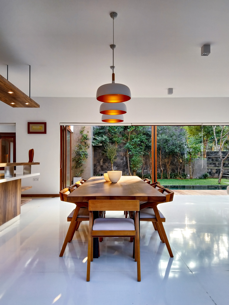 A dining room with a wooden table and chairs