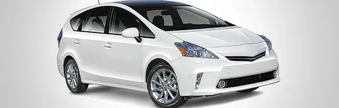 A white Toyota Prius V hatchback parked against a light gray background.