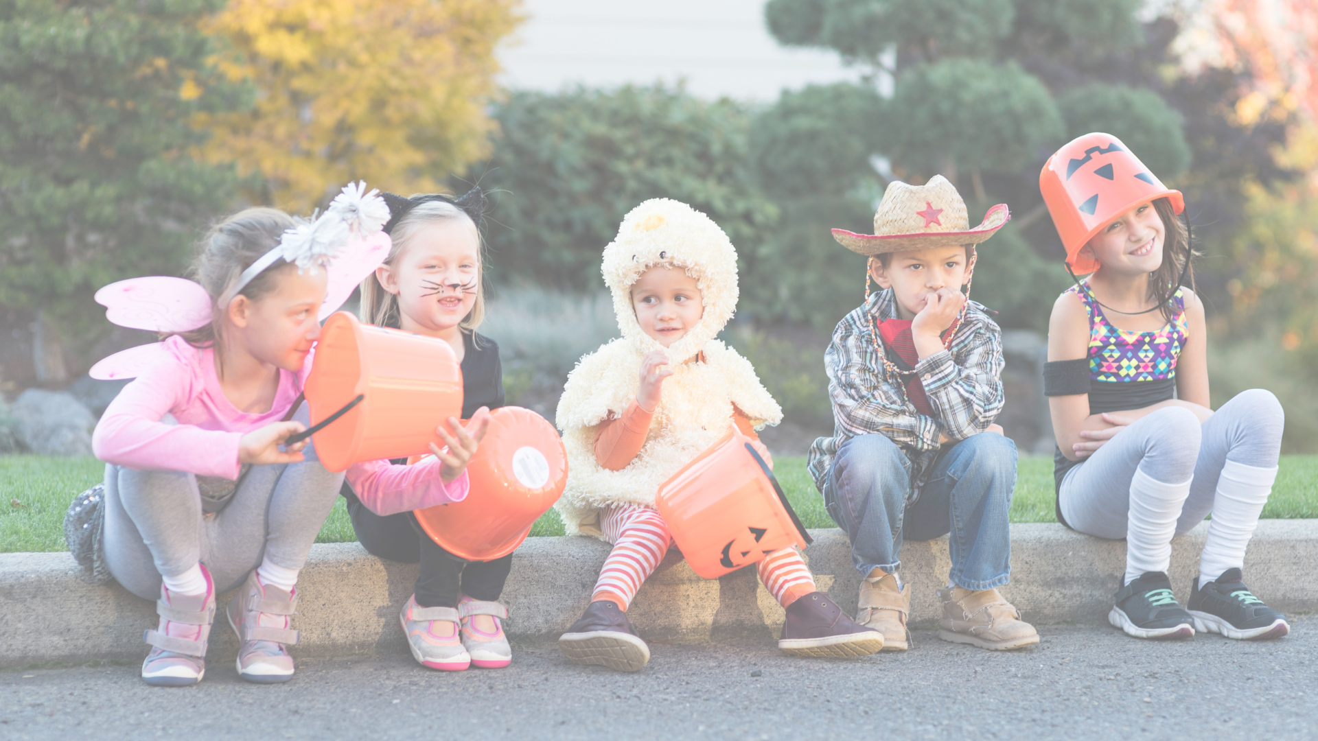 Photo: “Trick or treaters sitting on a curb” by FatCamera. Five kids dressed up sitting on a curb.