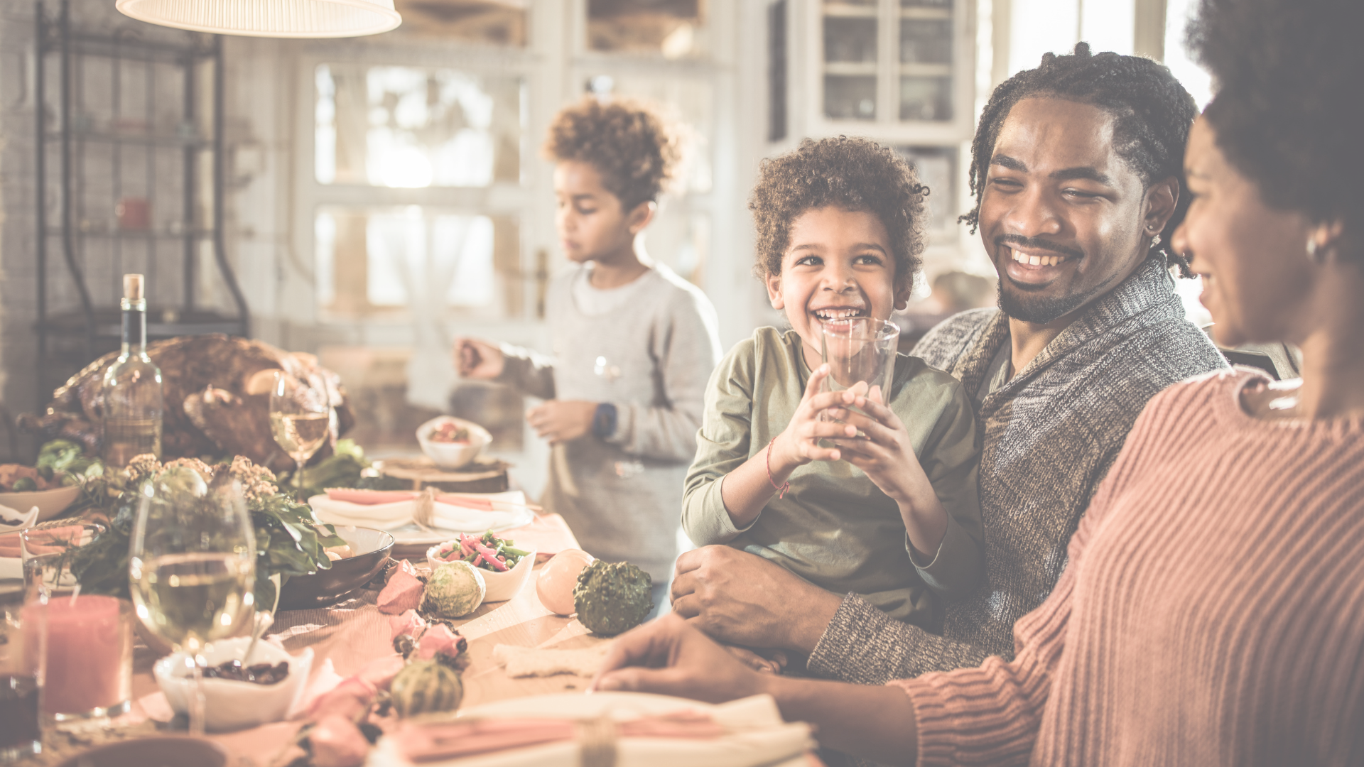 Photo: “Happy black family communicating during Thanksgiving meal in dining room” by skynesher