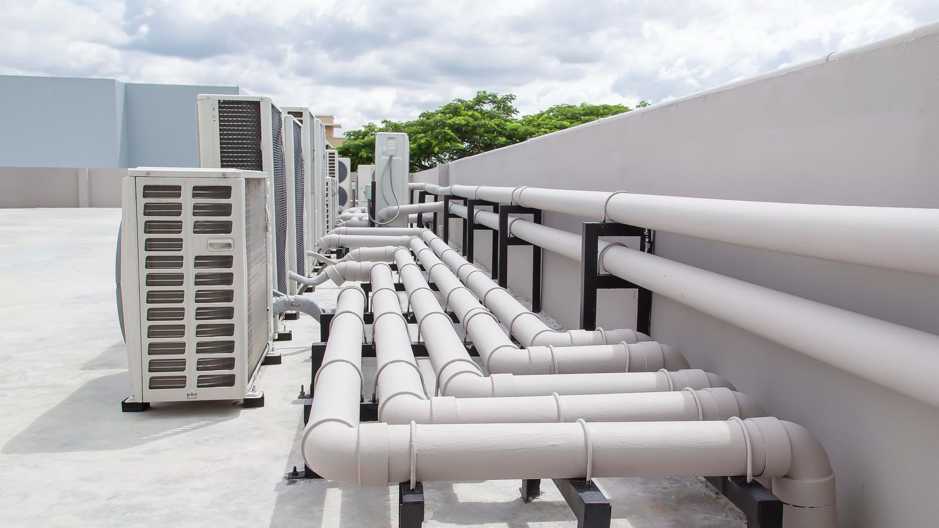Air conditioning units and piping on a rooftop.