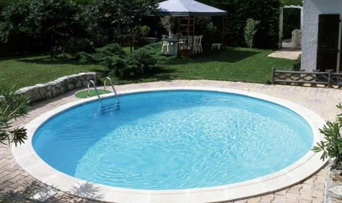 There is a large swimming pool in the middle of a house.