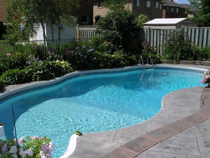 A modern house with a large swimming pool in front of it
