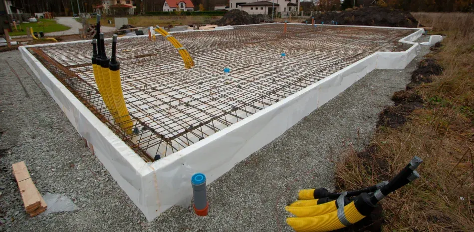 A concrete base for a house is being built.