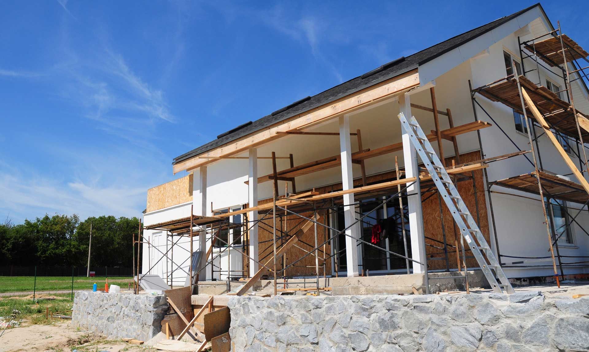 A house is being built with scaffolding around it.