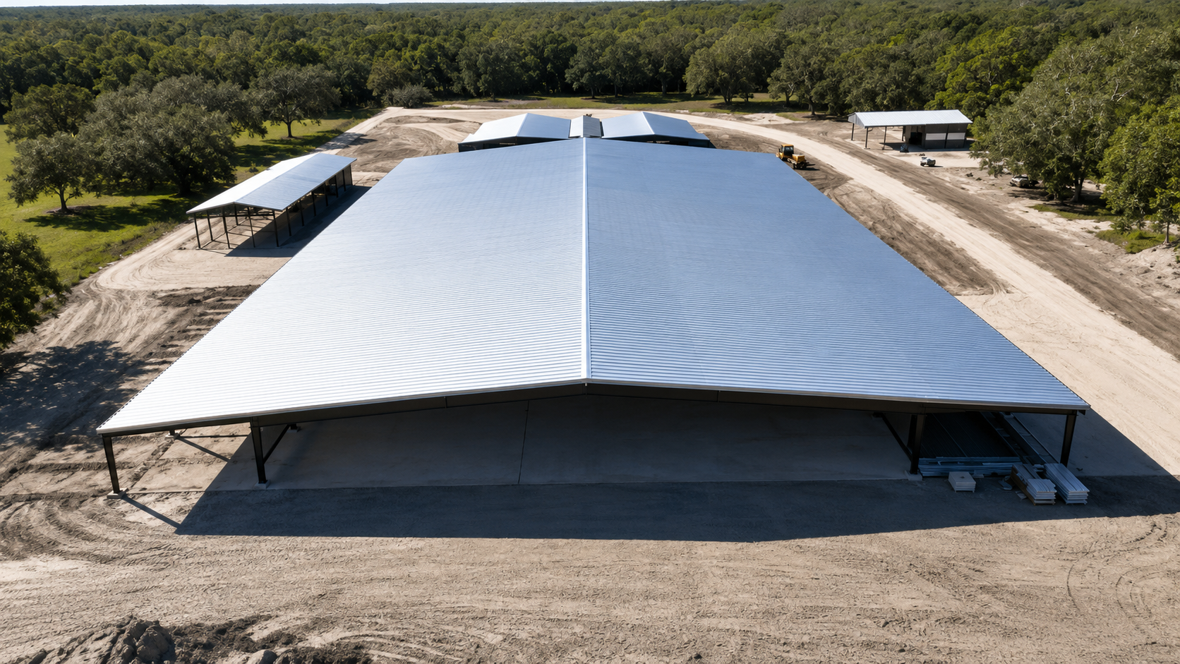 Wooden carport under construction; beams and supports visible, set in a yard.