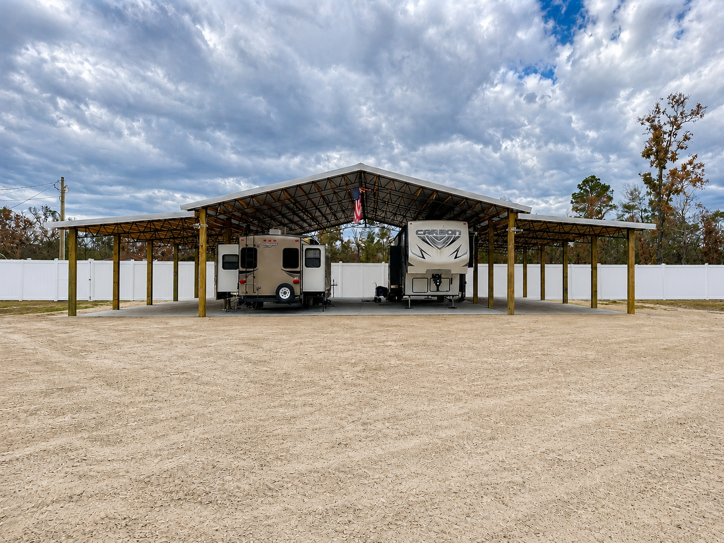 Construction site with a long, partially built wooden structure under a cloudy sky.