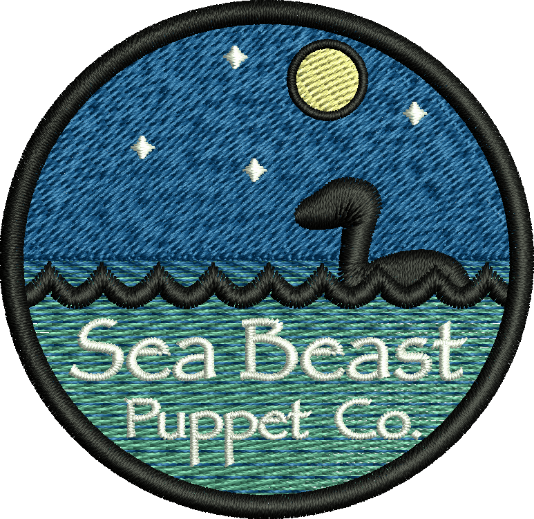 A patch that says sea beast puppet co. on it