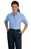 A woman is wearing a light blue shirt and blue pants.