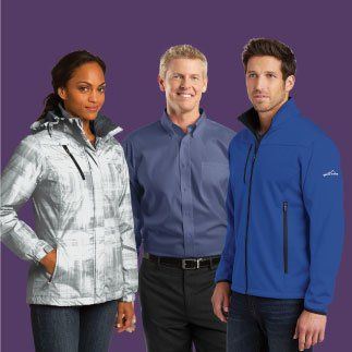 A woman in a white jacket is standing next to two men in blue jackets