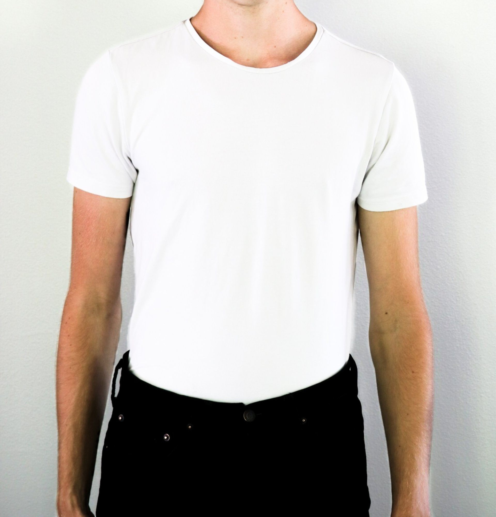 A man wearing a white t-shirt and black jeans