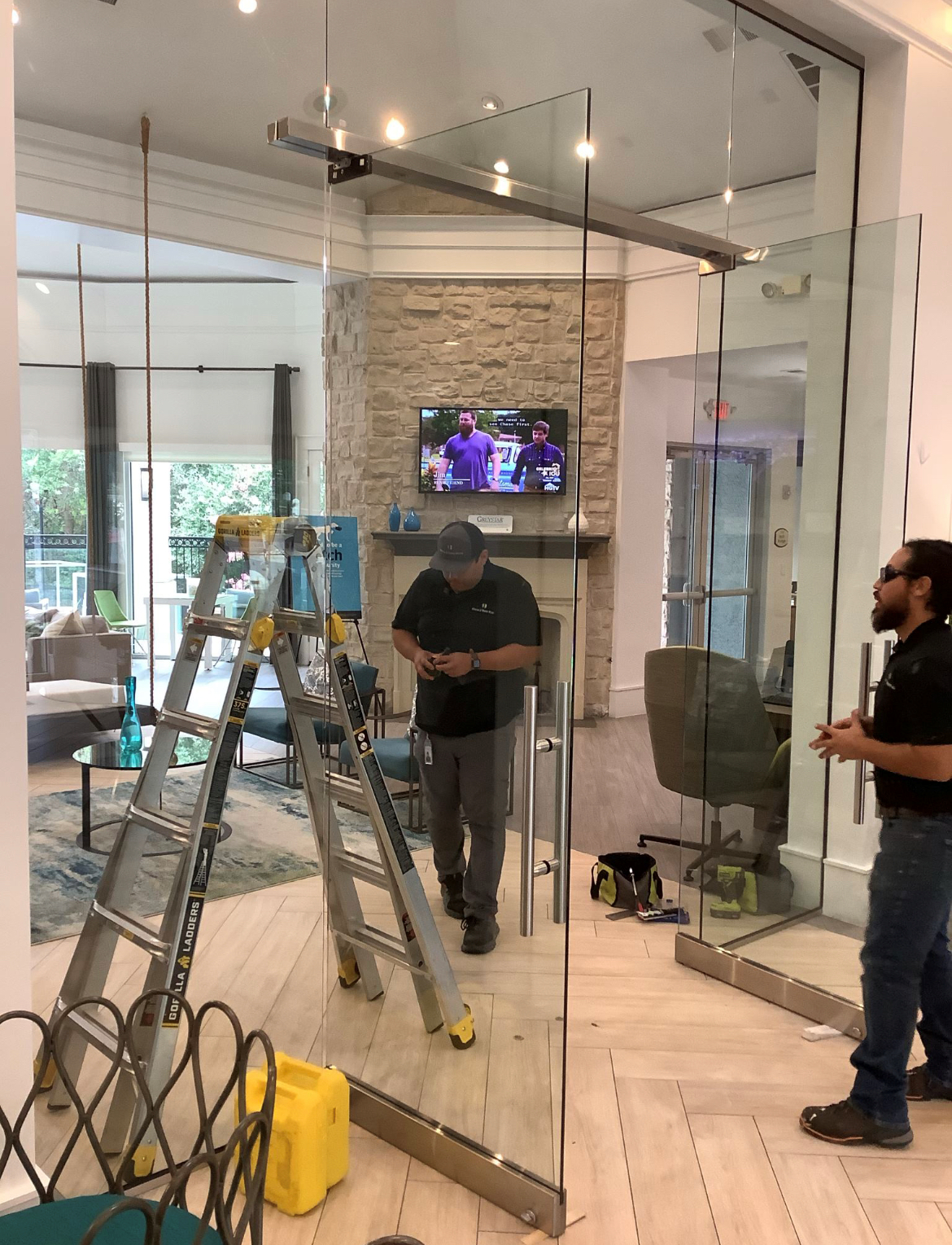 A man is standing next to a ladder in a living room.