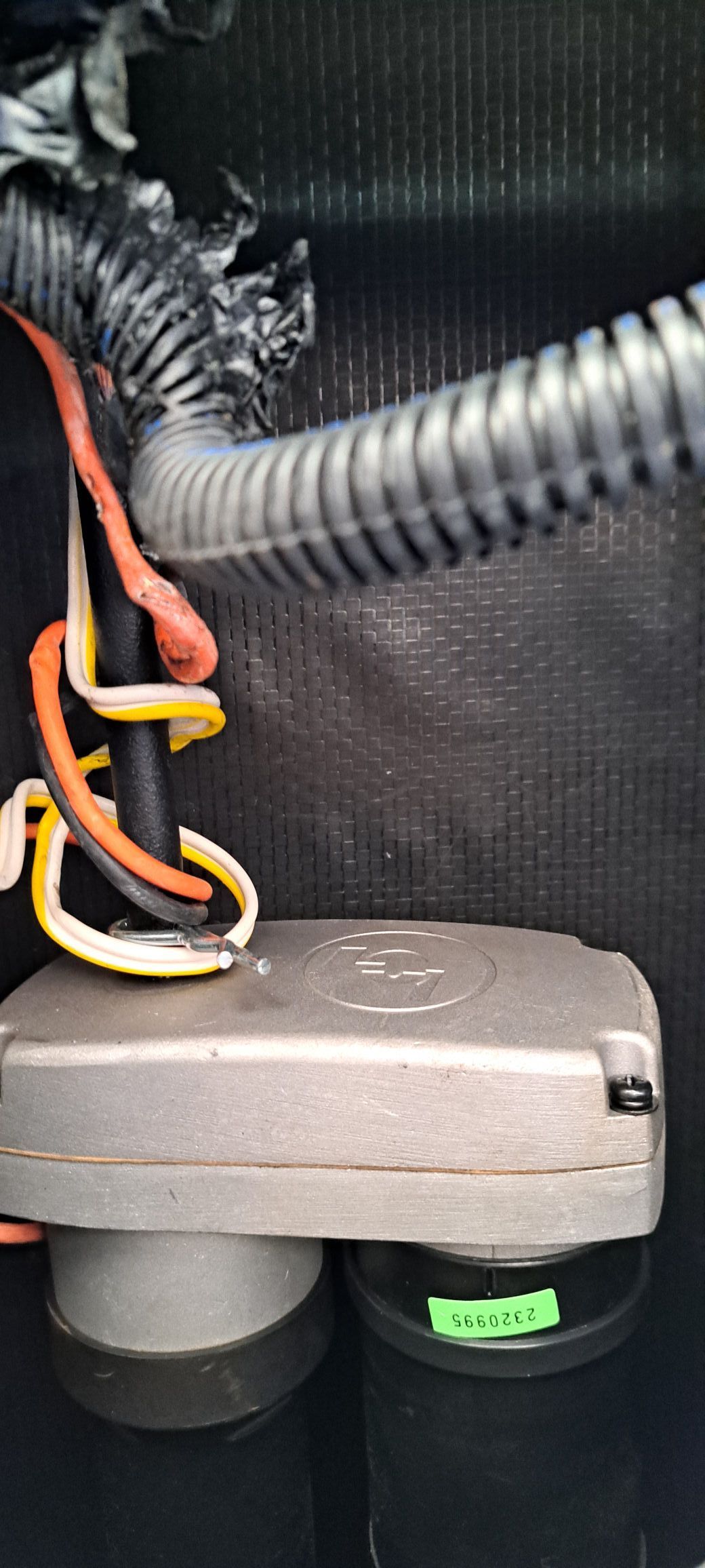 A close up of a box with wires coming out of it.