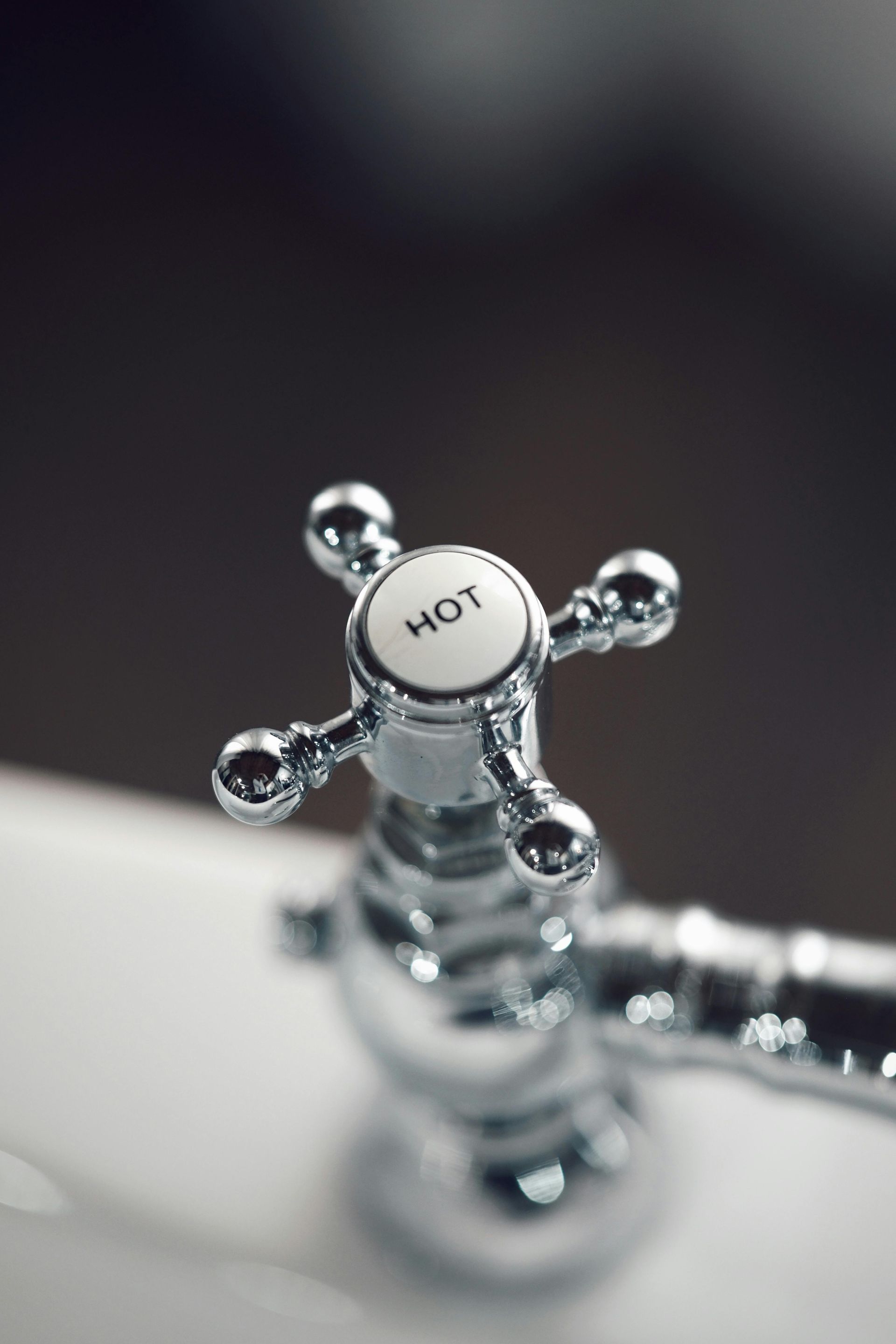 A close up of a faucet with the word hot on it