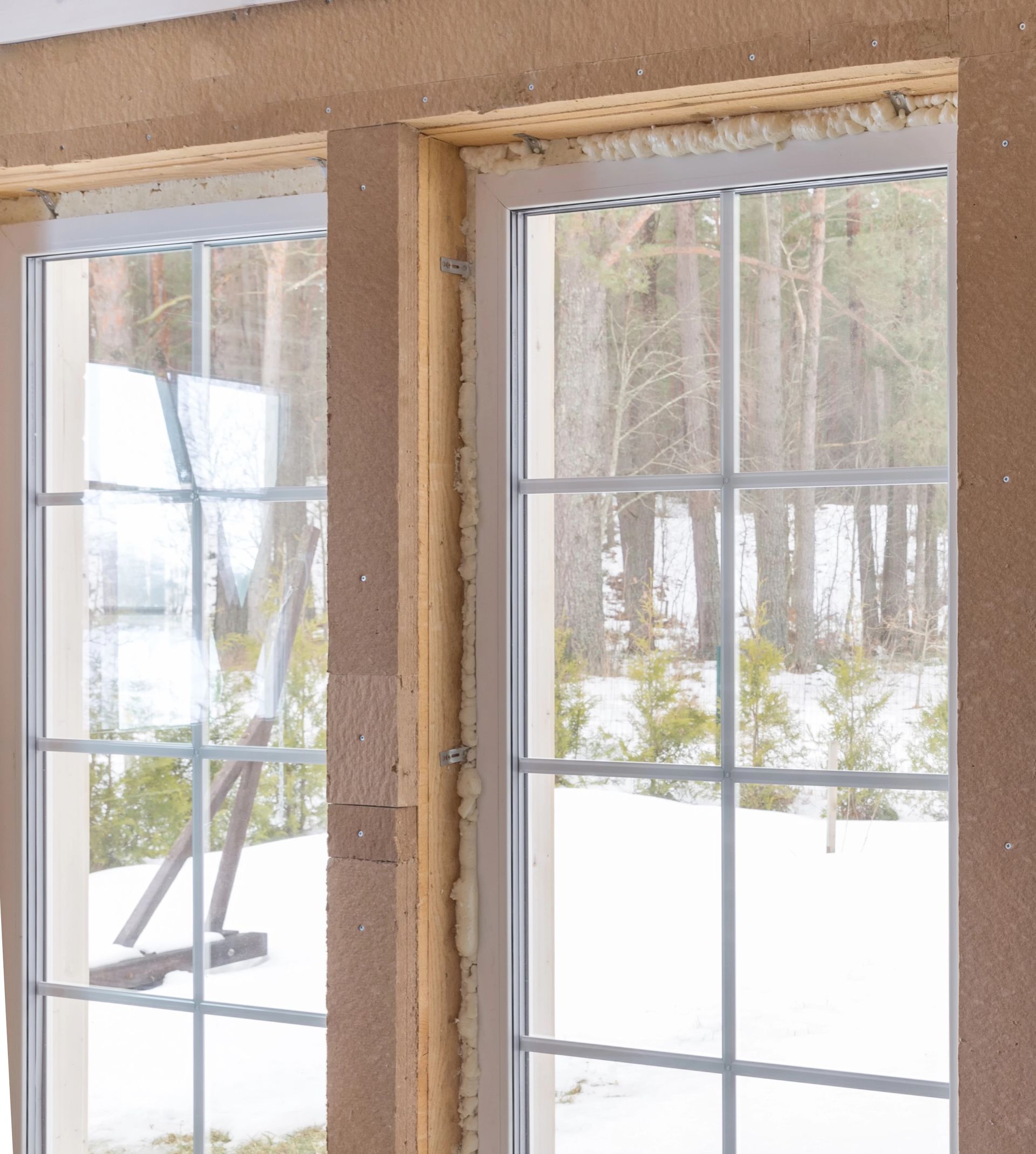 Foam insulation being injected into a window cavity in a Cheyenne, WY residence to help block drafts and reduce heat loss.