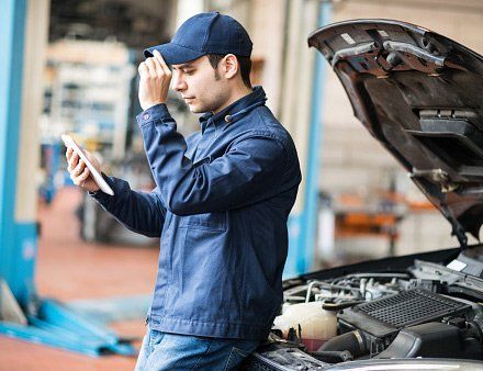 Auto Repair — Mechanic Using A Tablet in Round Lake Park, IL