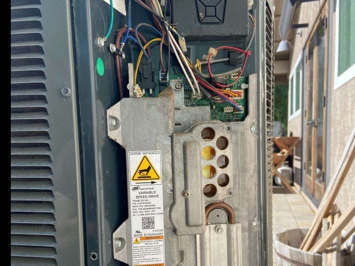 A close up of a machine with a warning label on it