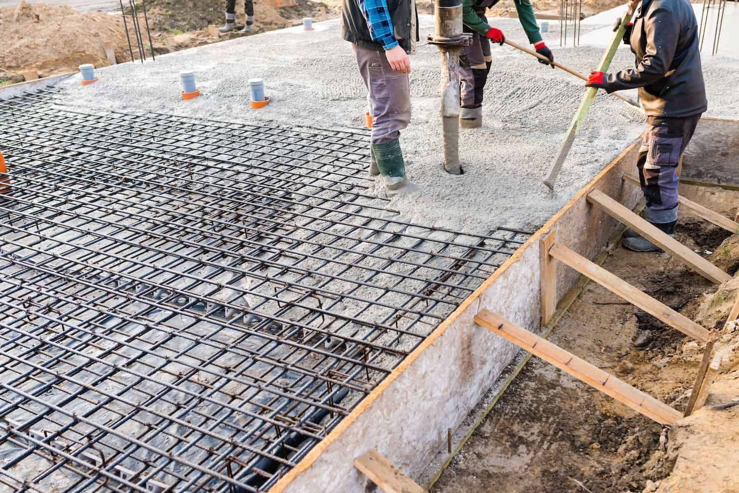 Pouring a concrete foundation over a rebar grid.