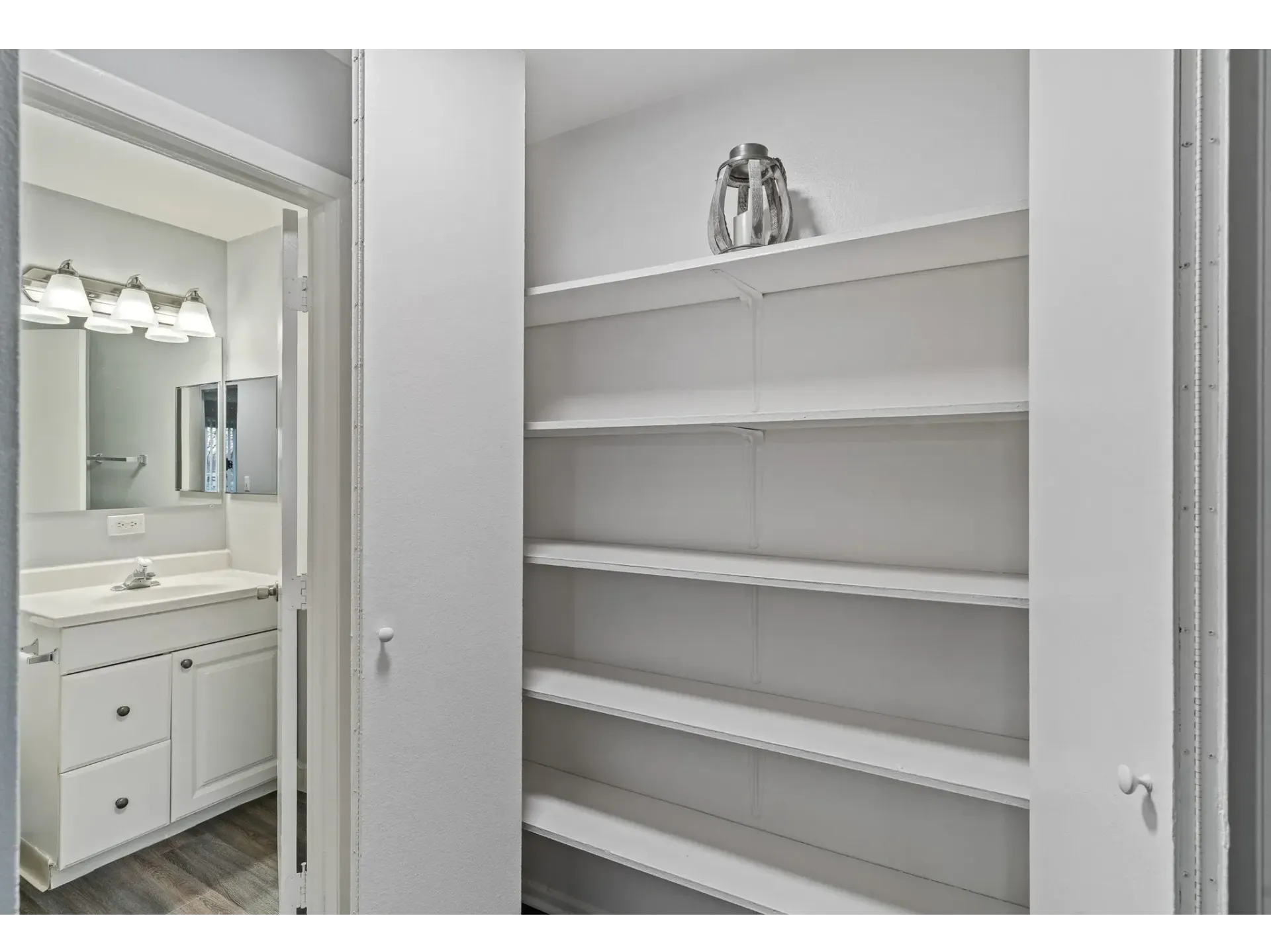 Interior view of an apartment bathroom with a sink and mirror