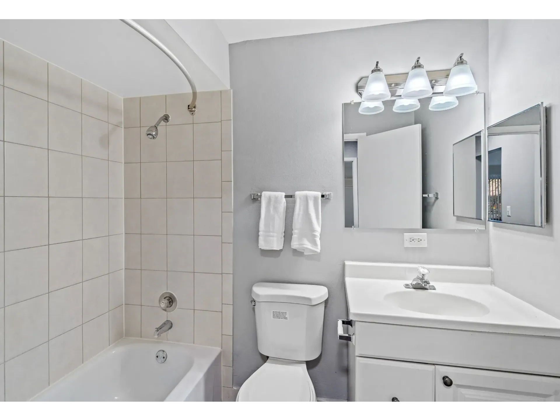 Bathroom featuring a tub, shower, toilet, and sink with a mirror