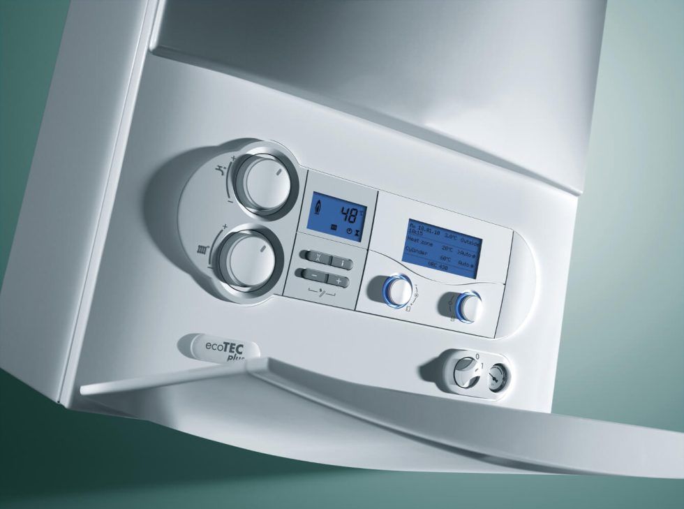 A white wall-mounted gas boiler featuring a digital display, control knobs, and buttons on its front panel.