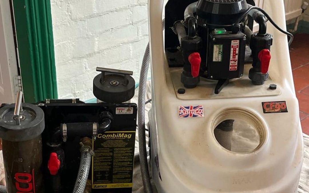 A professional carpet cleaning machine sitting on a white cloth in an indoor setting.