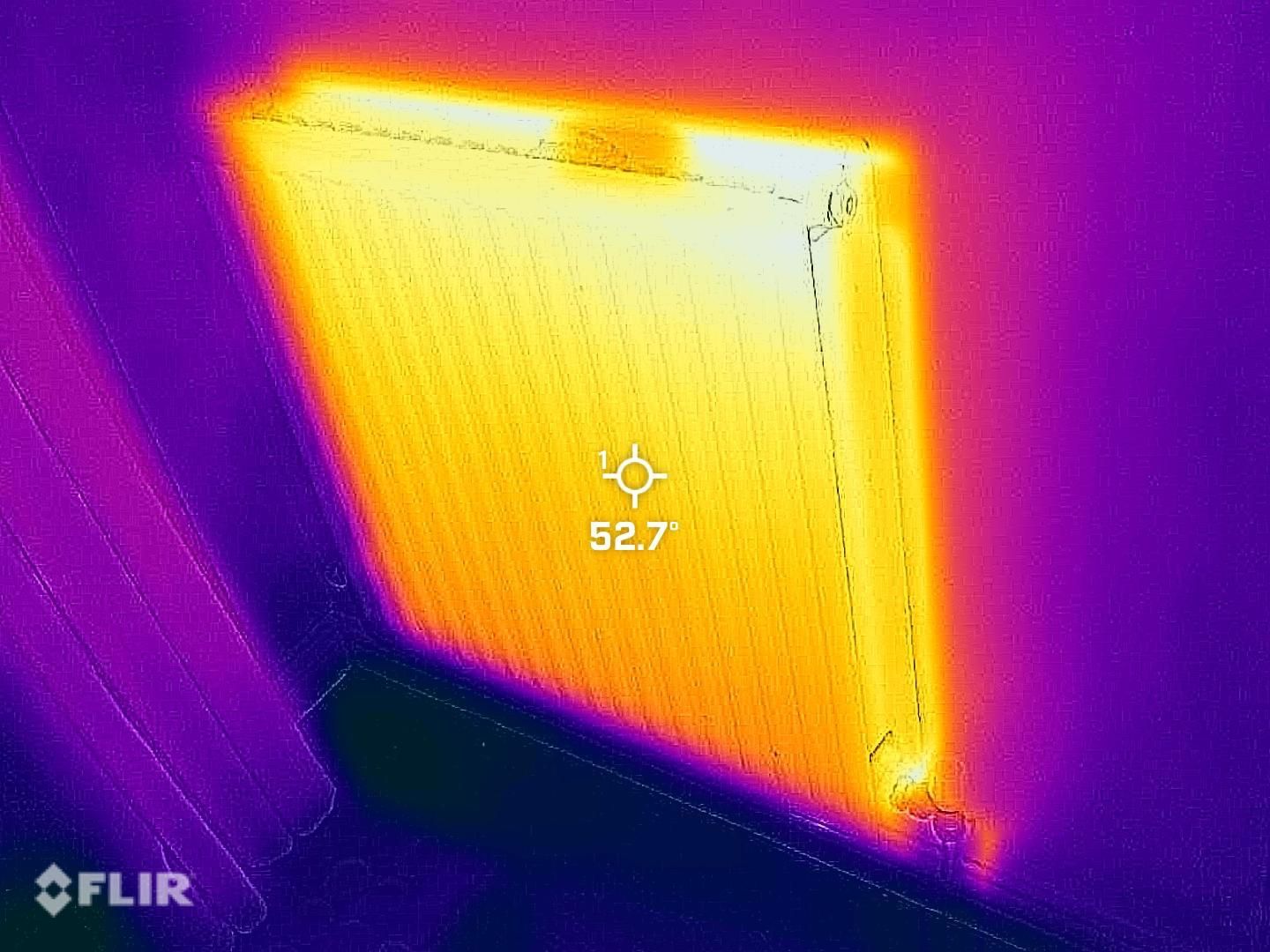 Thermal image of a heater mounted on a wall, showing a temperature reading of 52.7 degrees Celsius.