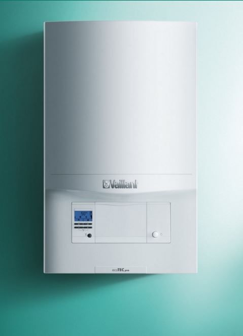 White Vaillant wall-mounted gas boiler with a digital display control panel against a teal background.