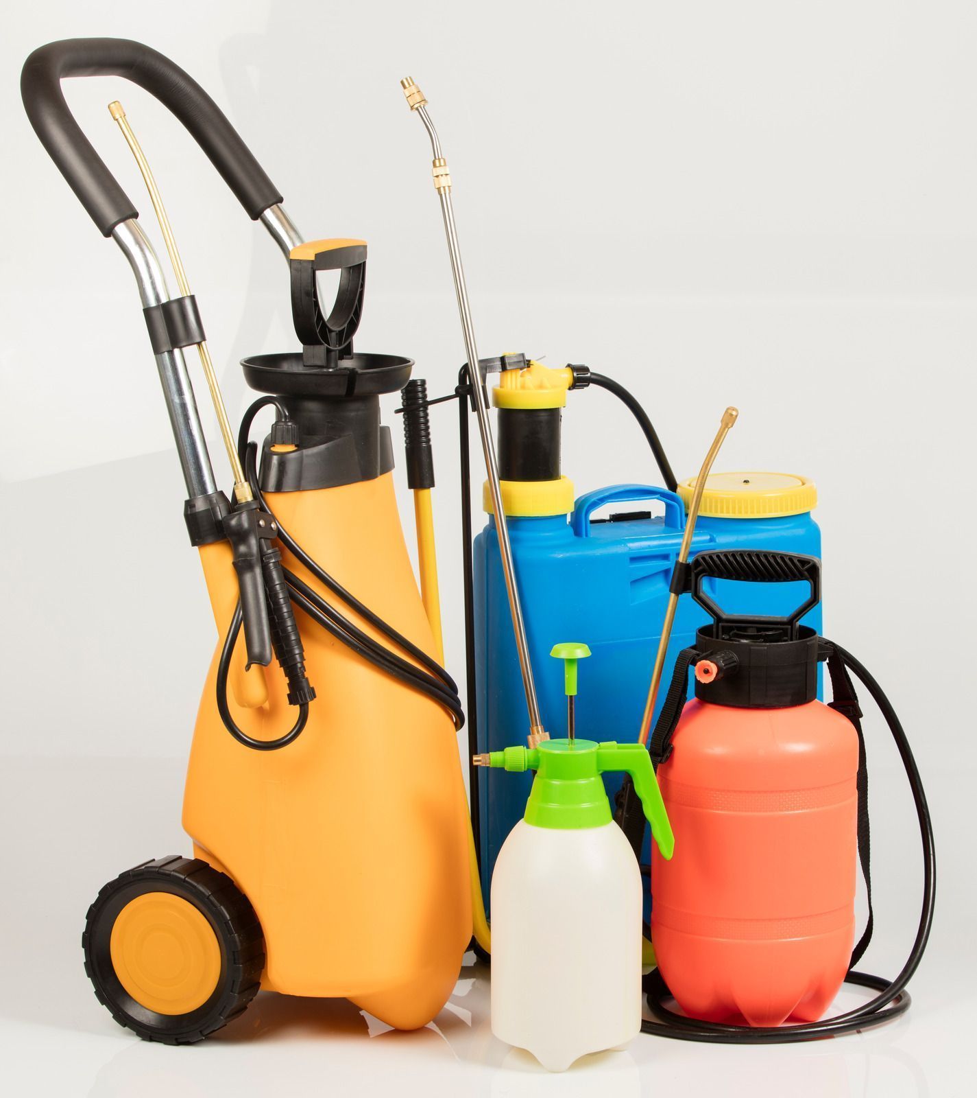 Various pesticide sprayers, including a wheeled, orange one, and several smaller hand-held types.