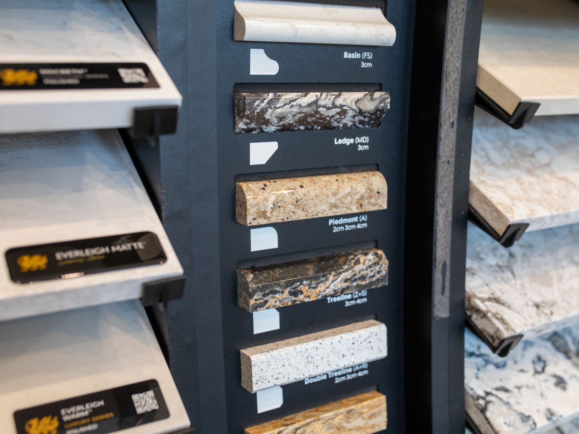 Display of countertop edge samples in various colors and styles.