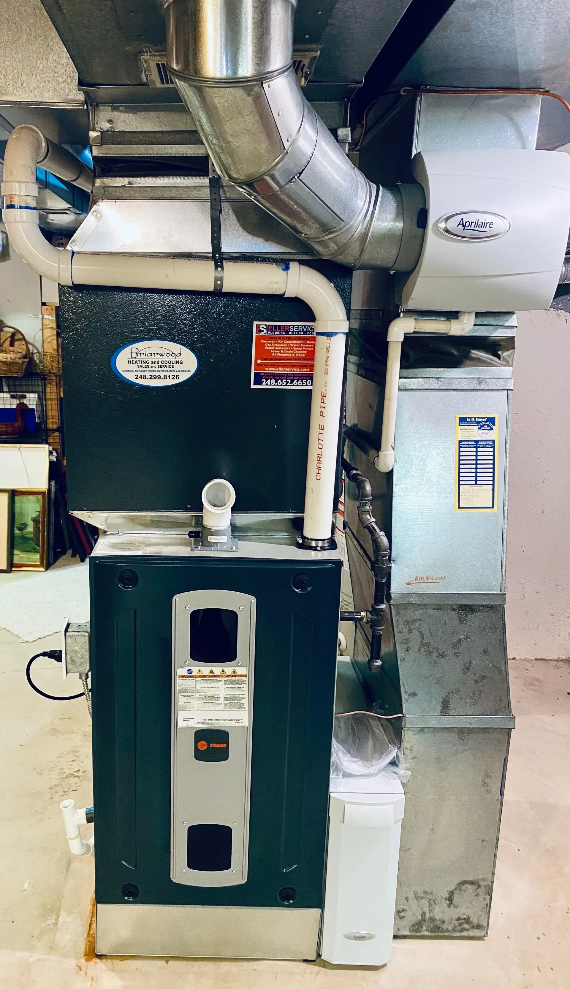 A green heating and cooling system is sitting in a basement.