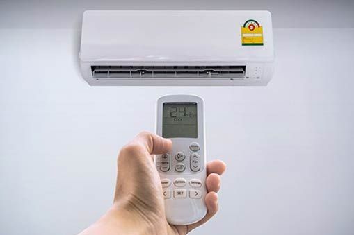 Air Conditioner and Remote Control — Rochester Hills, MI — Briarwood Heating & Cooling Air Conditioner and Remote Control — Rochester Hills, MI — Briarwood Heating & Cooling
