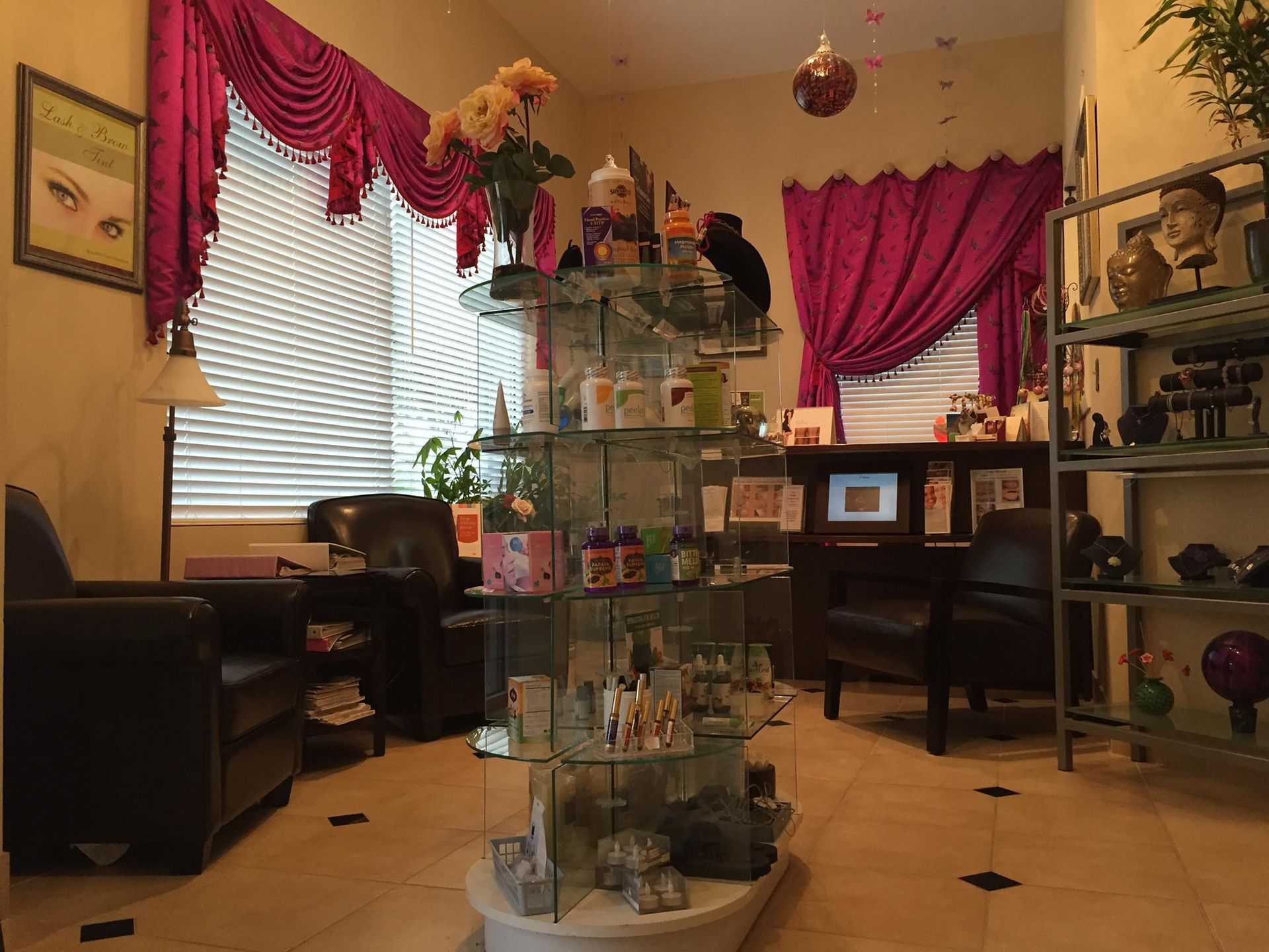 A waiting room with purple curtains and a display of items