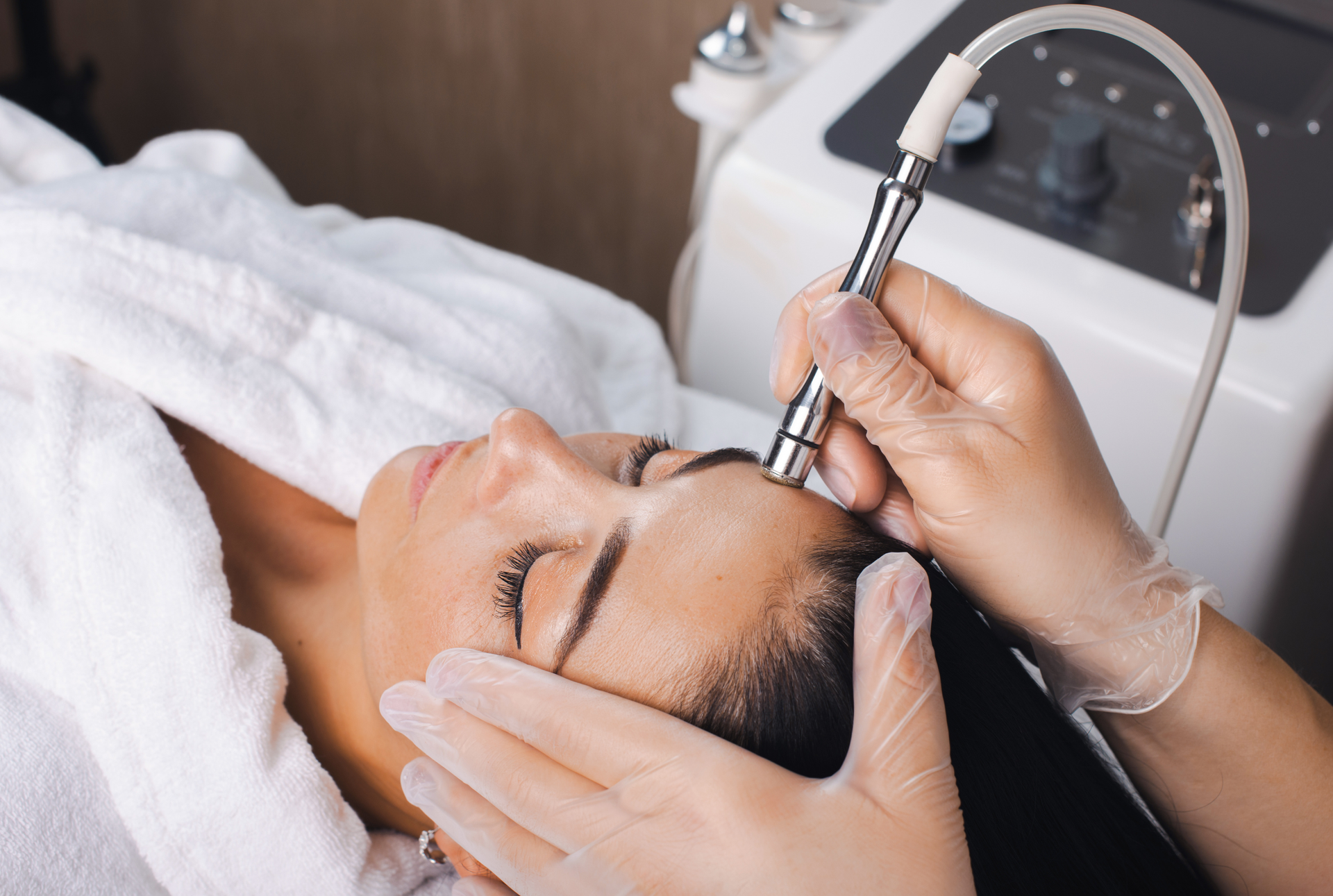 A woman is getting a facial treatment at a beauty salon.