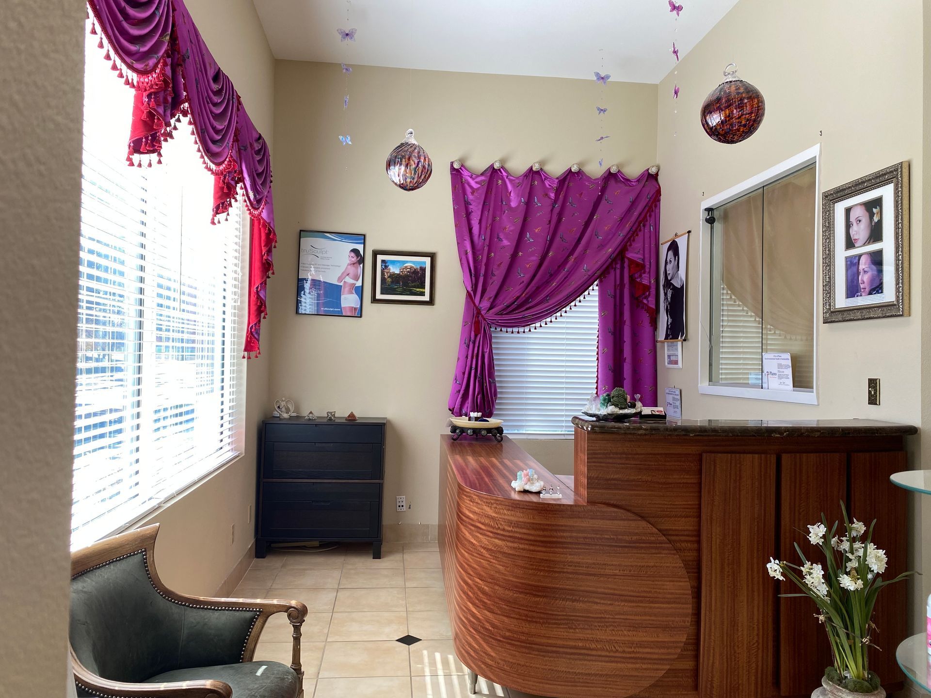 A room with purple curtains and a wooden desk