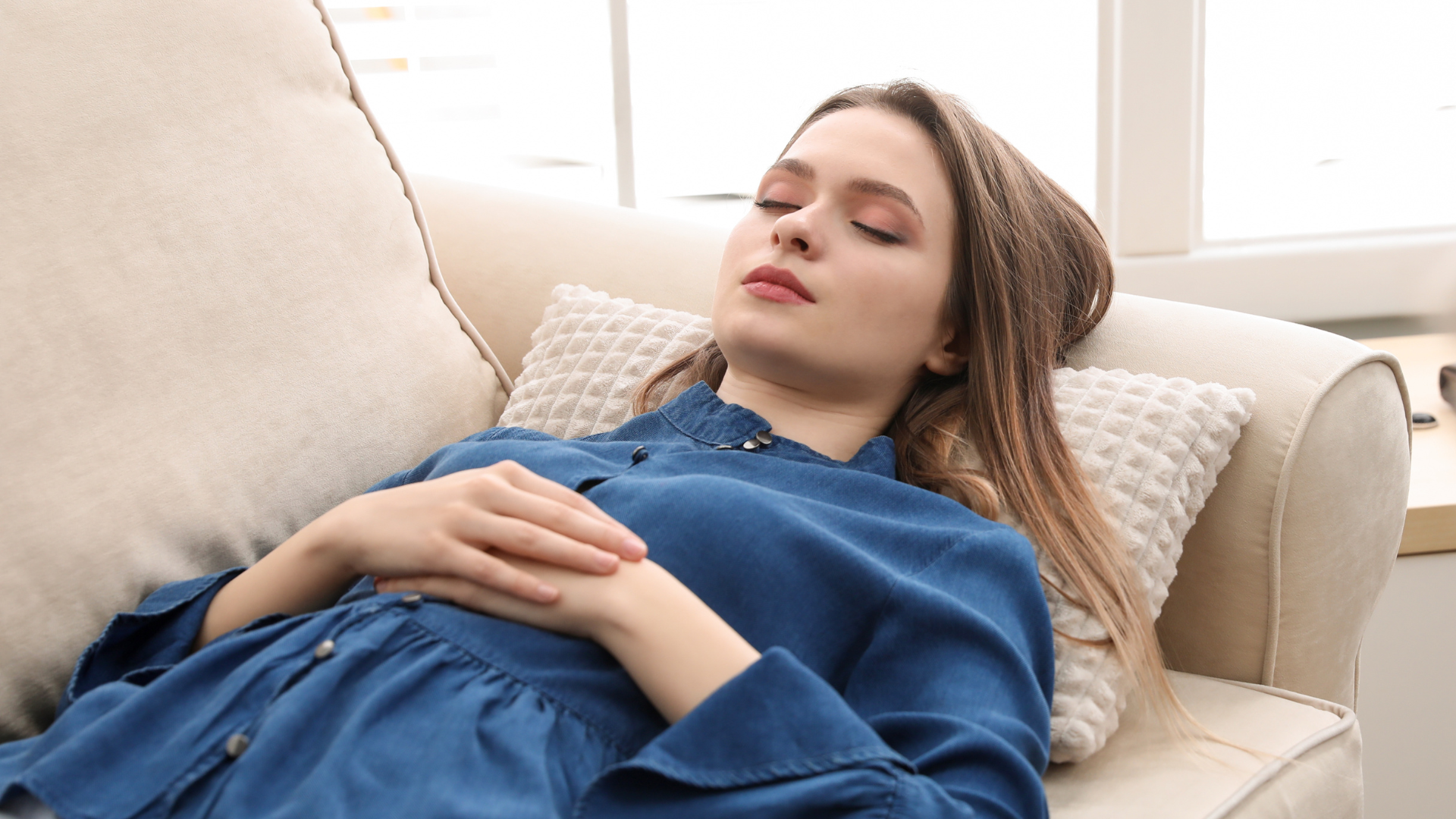 A woman is looking at her face in the mirror.