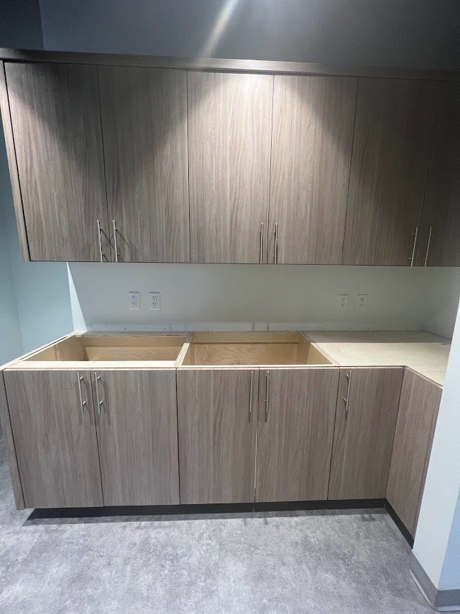 A kitchen with wooden cabinets and a sink.