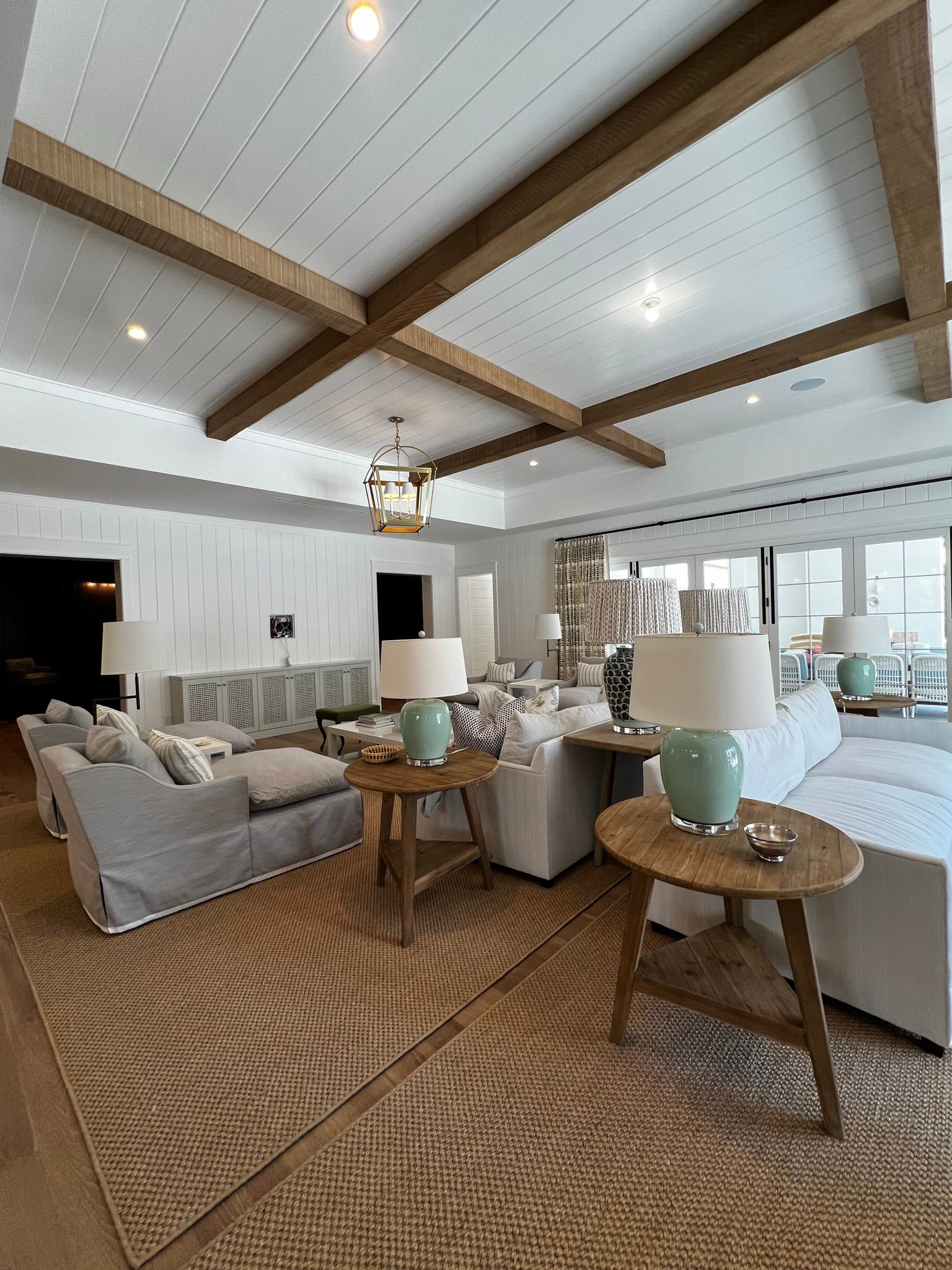 A living room filled with furniture and a wooden ceiling.