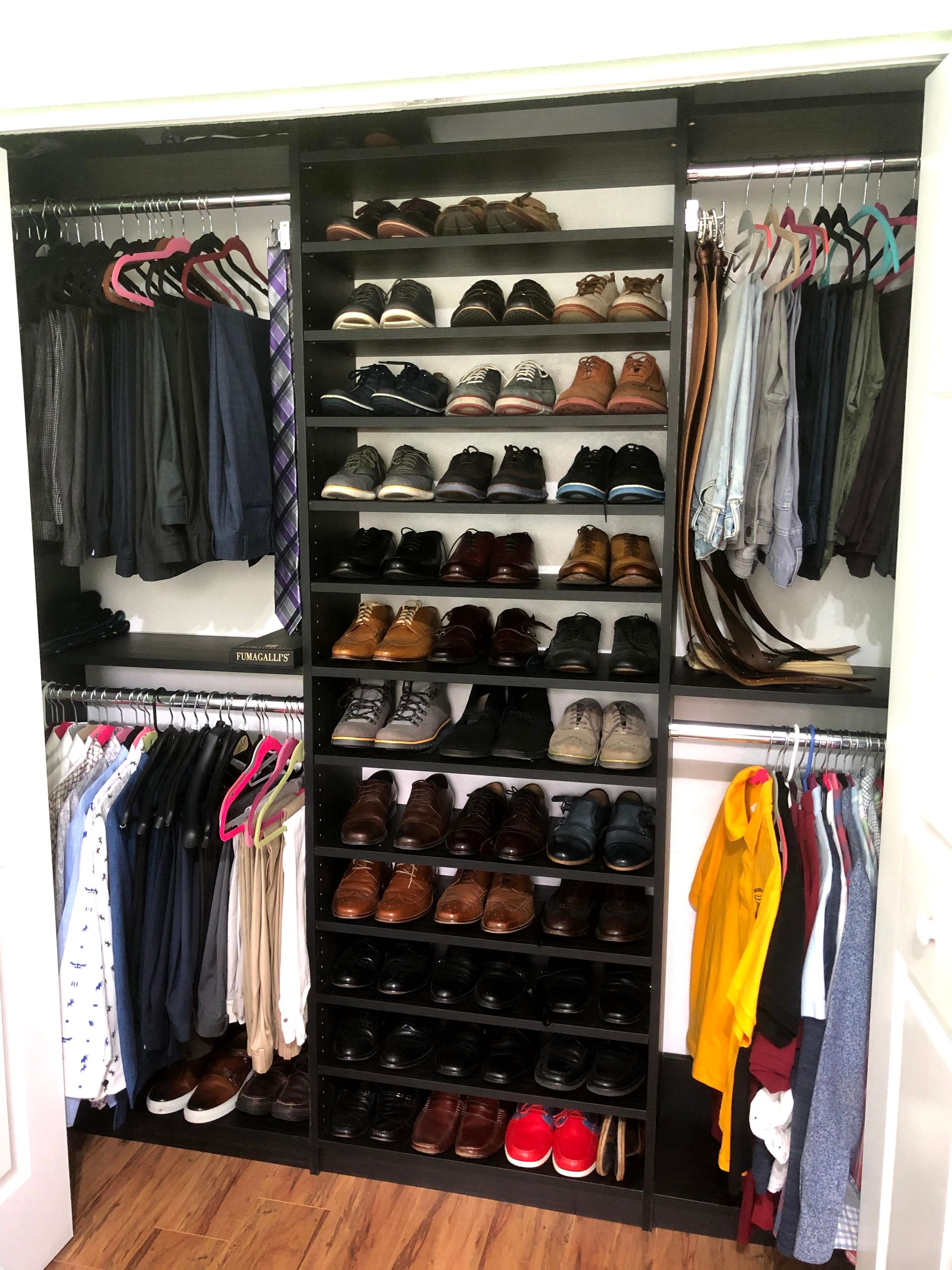 A closet filled with lots of clothes and shoes