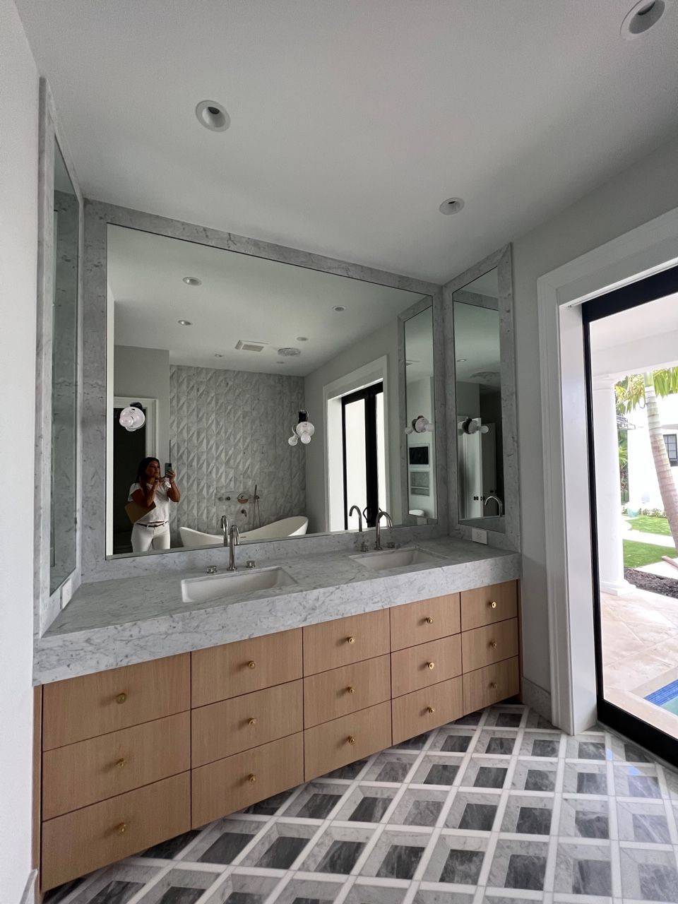 A bathroom with two sinks and a large mirror