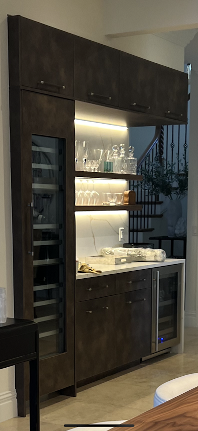 A kitchen with a wine cooler and a wine fridge.