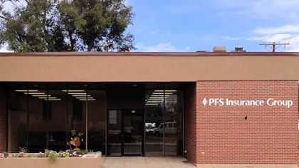 A brick building with a sign that says pfs insurance group