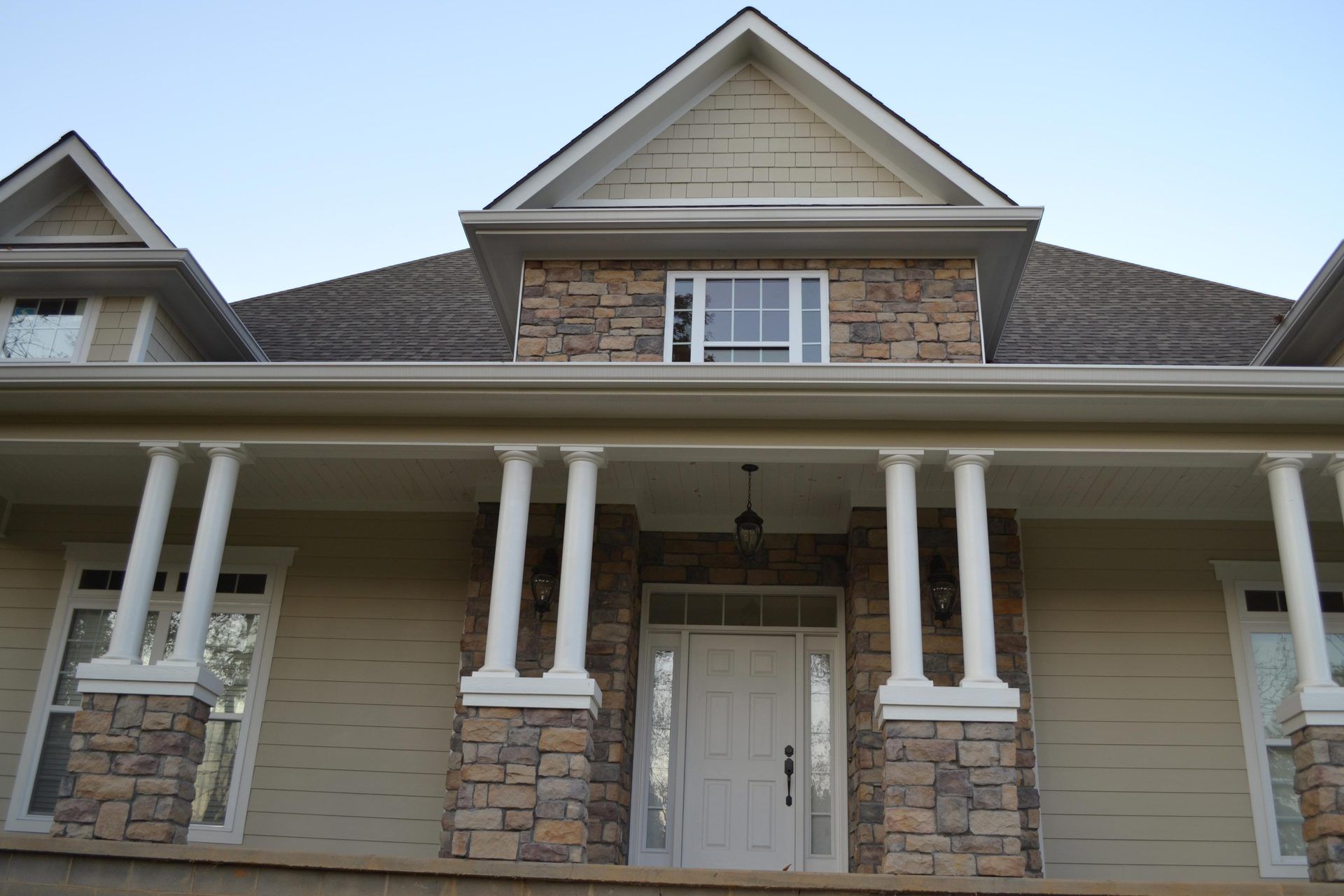 The front of a house with a porch and columns