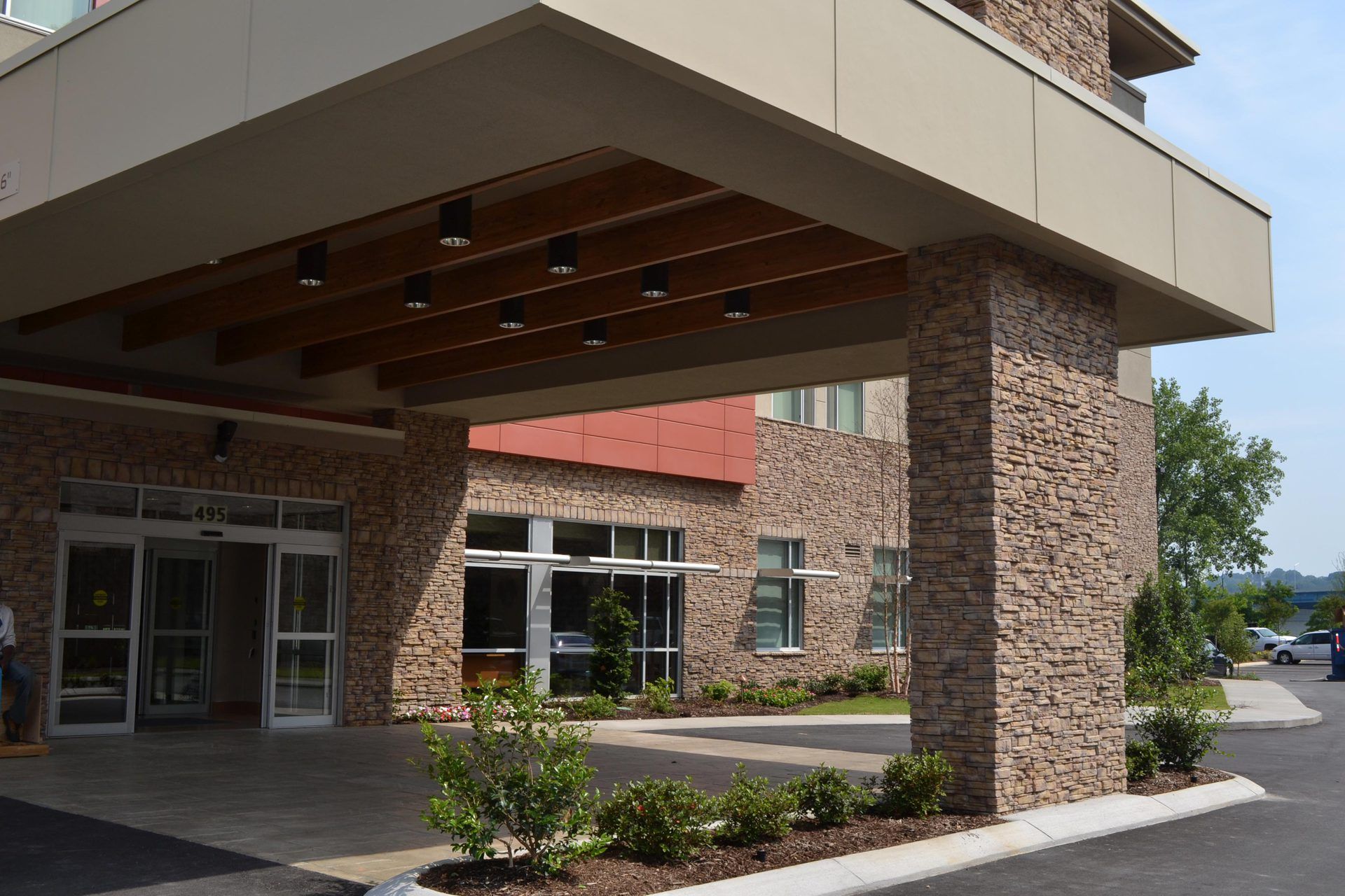 A large brick building with a canopy over the entrance.