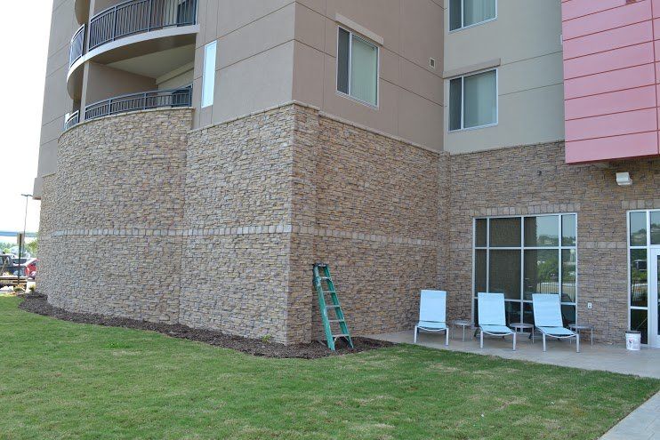 A building with a lot of windows and chairs in front of it