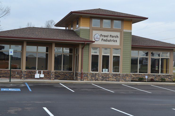 A large building with a parking lot in front of it.