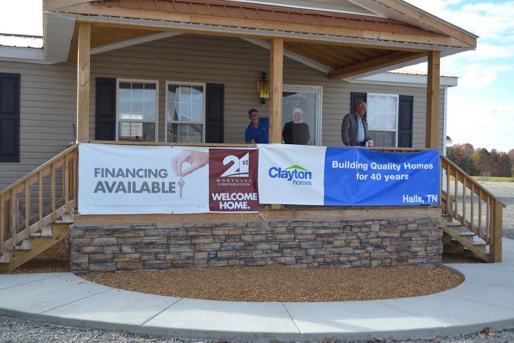 A house with a banner on the porch that says financing available