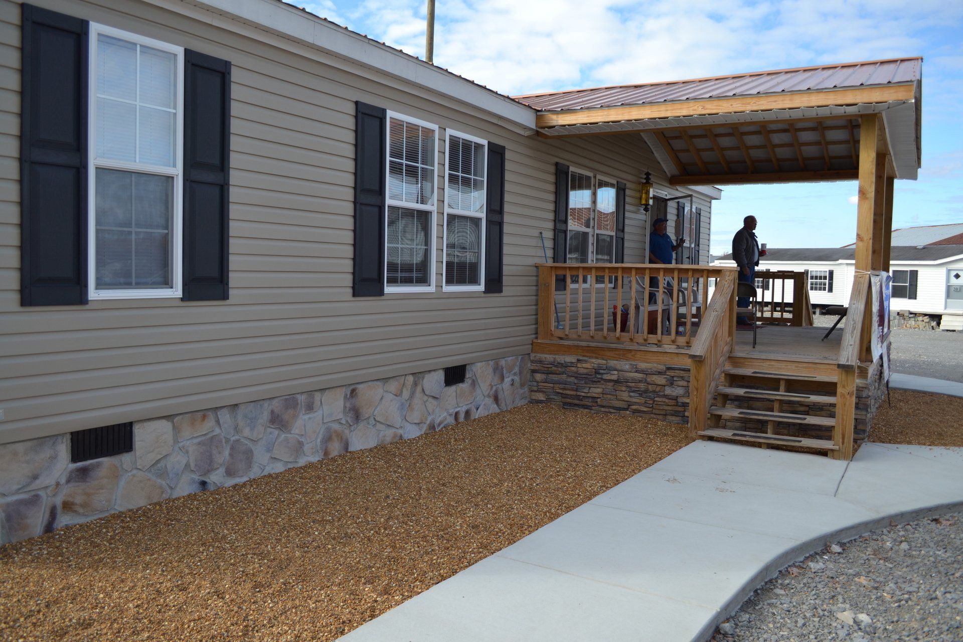 A mobile home with a porch and stairs